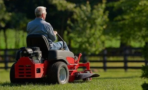 Riding mower cutting a lawn