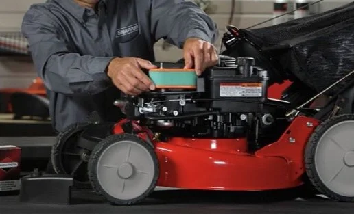 Technician working on a mower engine